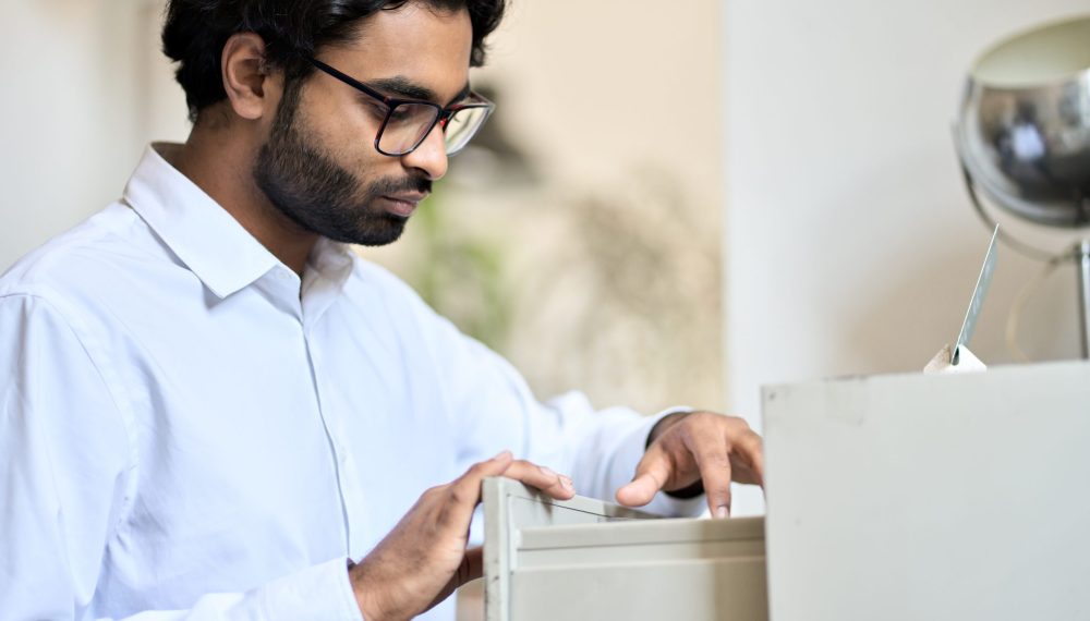 Indian,Business,Man,Searching,Corporate,Documents,In,Archive,Drawer.,Files Indian,Business,Man,Searching,Corporate,Documents,In,Archive,Drawer.,Files