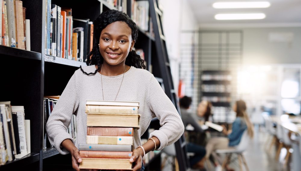 Black,Woman,,Student,With,Book,Stack,In,Library,And,Research Black,Woman,,Student,With,Book,Stack,In,Library,And,Research