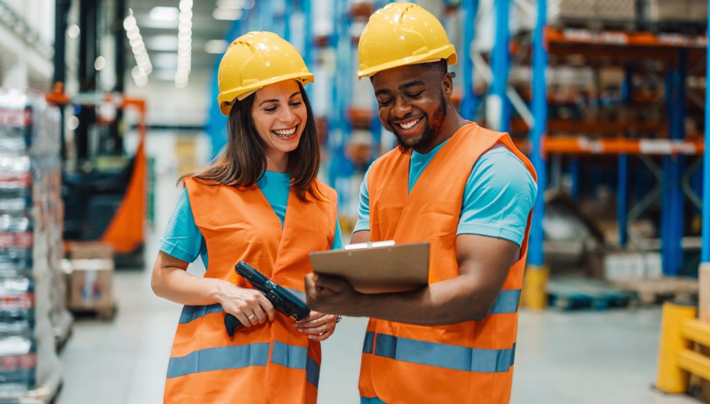 Two,Diverse,Colleagues,Wearing,Yellow,Hard,Hats,And,Orange,Safety Two,Diverse,Colleagues,Wearing,Yellow,Hard,Hats,And,Orange,Safety