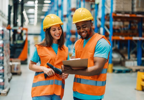 Two,Diverse,Colleagues,Wearing,Yellow,Hard,Hats,And,Orange,Safety Two,Diverse,Colleagues,Wearing,Yellow,Hard,Hats,And,Orange,Safety
