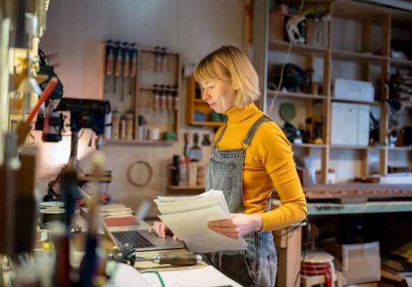 Glad,Confident,Female,Carpenter,Working,On,Client,Orders,With,Database