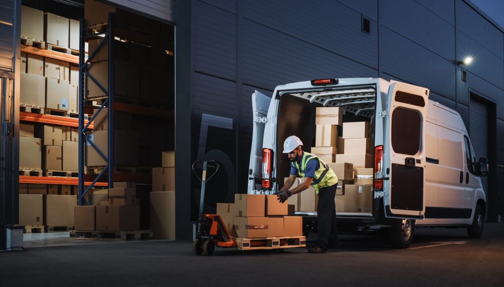 Outside,Of,Logistics,Distributions,Warehouse,Delivery,Van:,Worker,Unloading,Cardboard Outside,Of,Logistics,Distributions,Warehouse,Delivery,Van:,Worker,Unloading,Cardboard