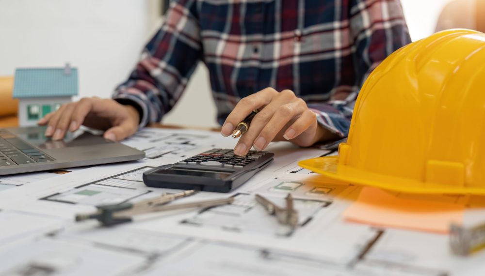 Close,Up,Architect,Or,Engineer,Using,On,Calculator,For,Calculating