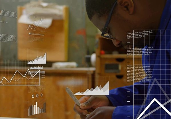 Reviewing,Smartphone,Charts,,Technician,In,Coveralls,Holding,Stylus,In,Woodshop,