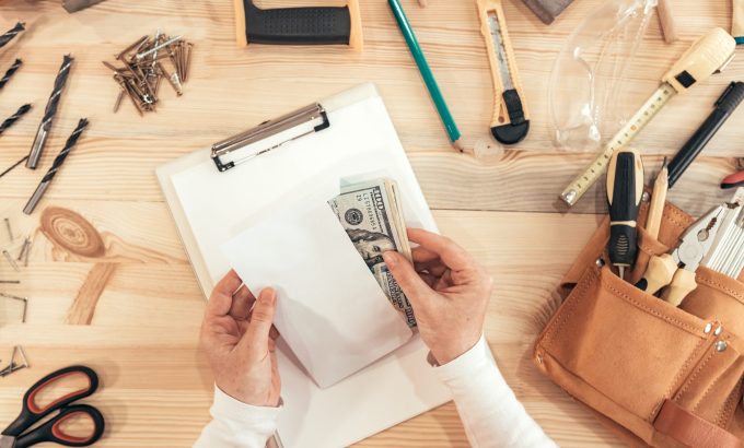Female,Carpenter,Counting,Money,,Top,View,Of,Hands,Holding,Us