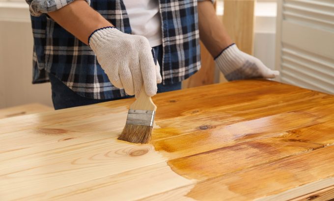 Man,With,Brush,Applying,Wood,Stain,Onto,Wooden,Surface,Indoors,