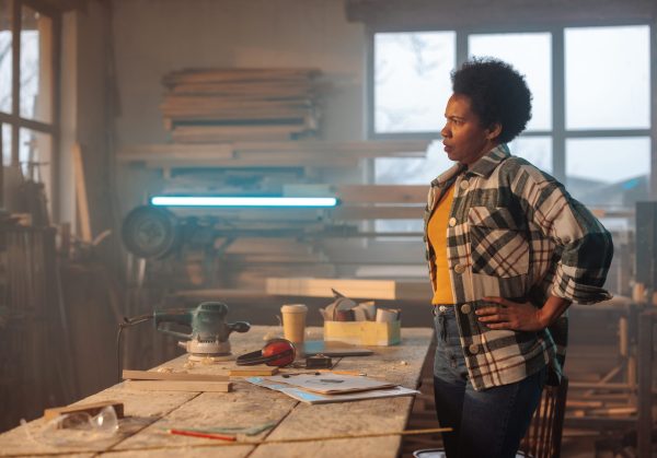 A,Stressed,Female,African,American,Carpenter,Is,In,Her,Workshop,