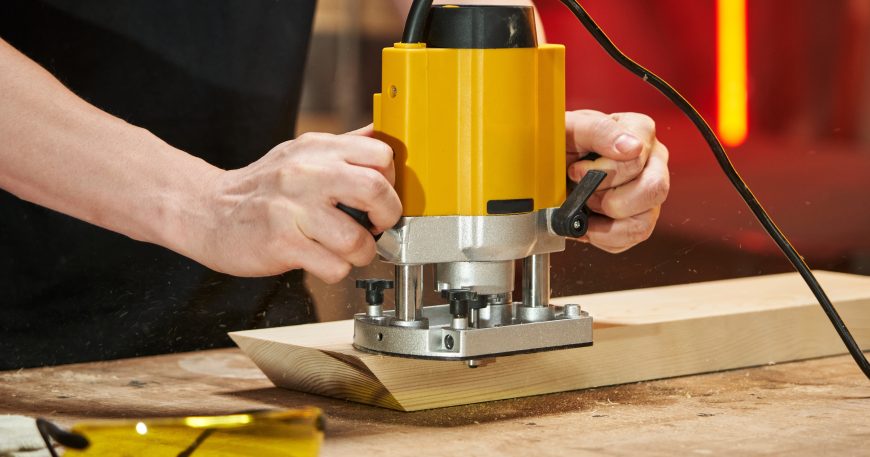 Router basics for beginners using a woodworking router tool on a wooden board