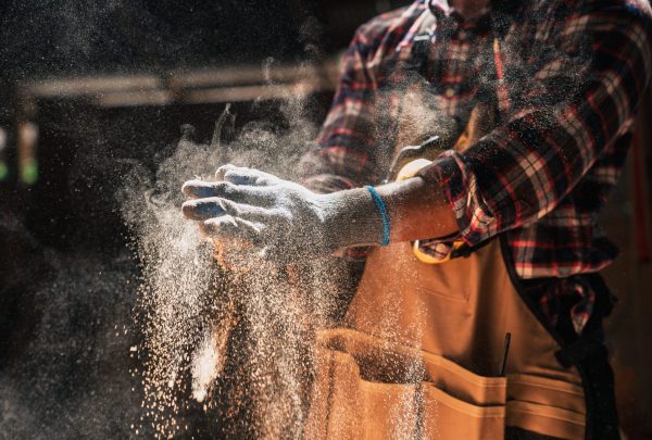 Close,Up,Skilled,African,American,Carpenter,Dusts,Gloves,In,Woodshop Close,Up,Skilled,African,American,Carpenter,Dusts,Gloves,In,Woodshop