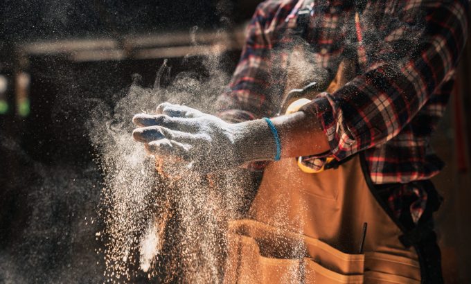 Close,Up,Skilled,African,American,Carpenter,Dusts,Gloves,In,Woodshop Close,Up,Skilled,African,American,Carpenter,Dusts,Gloves,In,Woodshop