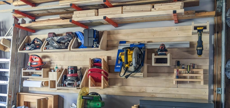 Woodworking tool storage organization with wall shelves and workshop equipment