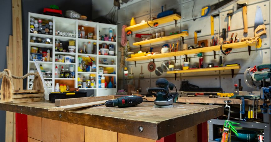 Workshop storage system with organized tools and workspace for woodworking projects