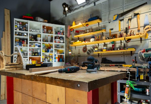 Workshop storage system with organized tools and workspace for woodworking projects